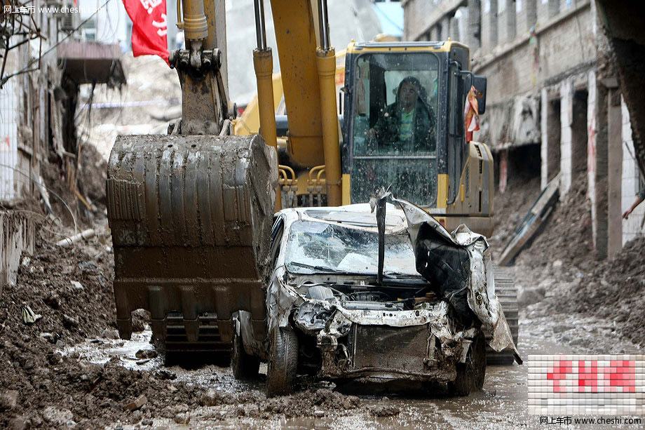 8月18日，甘肃舟曲泥石流灾区，一辆挖掘机将一辆被泥石流冲毁的小轿车从废墟中推了出来，让前来认领的车主将车拉走。